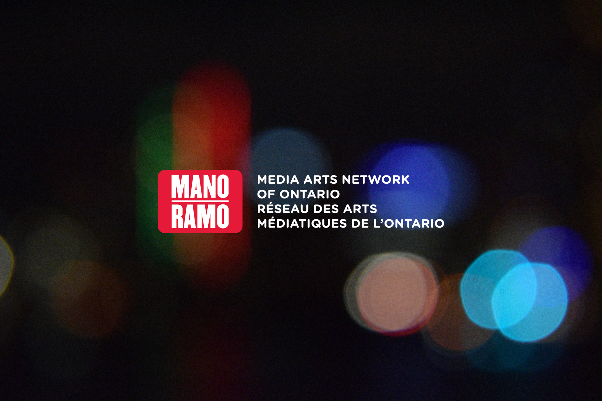 The red and white MANO logo on a dark background with coloured lights.